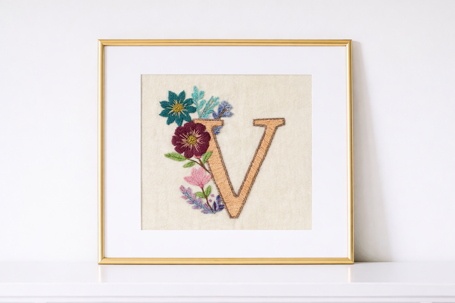 Framed hand-embroidered personalized artwork displayed on shelf
